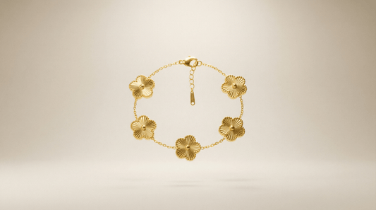 Flower Charm Bracelet – Elegant gold bracelet with floral accents against a soft background.