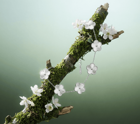 Flower Charm Bracelet displayed on a mossy branch with white floral accents, showcasing elegant floral jewelry for women.