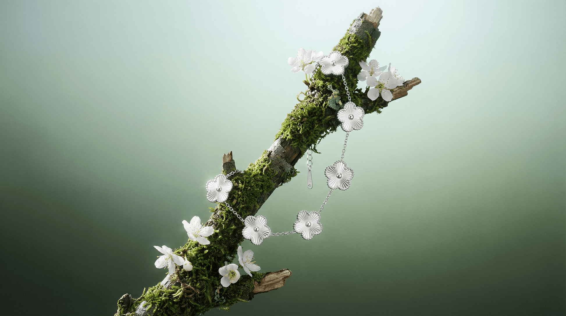 Flower Charm Bracelet displayed on a mossy branch with white floral accents, showcasing elegant floral jewelry for women.