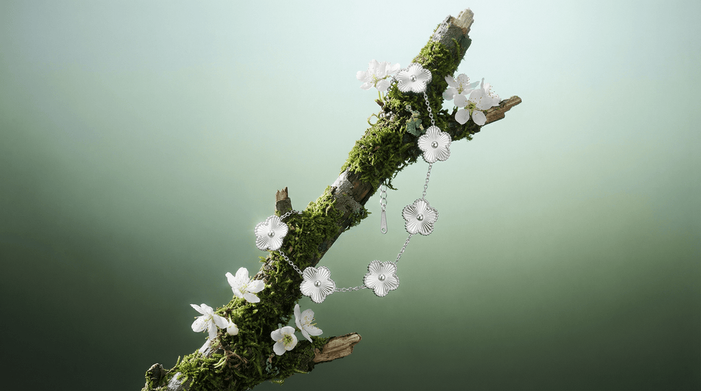 Flower Charm Bracelet displayed on a mossy branch, featuring elegant floral details that highlight beauty and femininity.