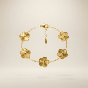 Flower Charm Bracelet – Elegant gold bracelet with floral accents against a soft background.