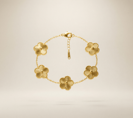 Flower Charm Bracelet – Elegant gold bracelet with floral accents against a soft background.