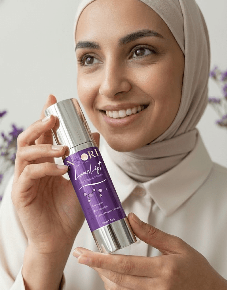 Woman holding Luna Lift Facial Serum with a smile, showcasing its halal-certified skin lifting benefits.
